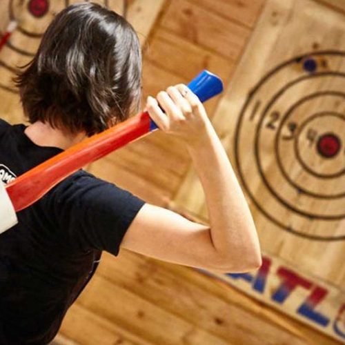 Epic Axe Throwing girls about to throw a red axe