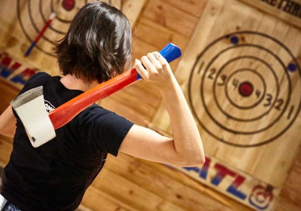 Epic Axe Throwing girls about to throw a red axe